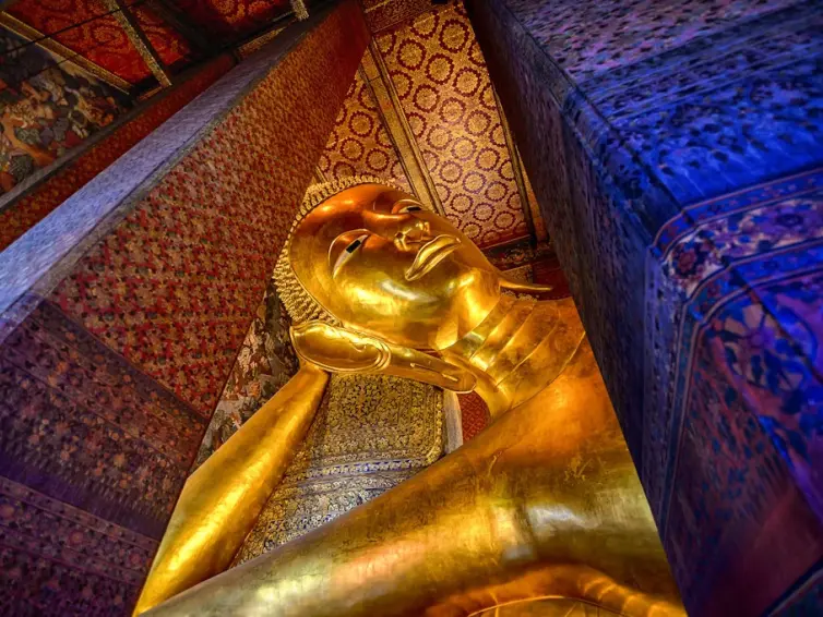 The Reclining Buddha inside the Wat Phra Chetuphon Vimolmangklararm Rajwaramahaviharn in a Buddhist temple complex of Wat Pho in the Phra Nakhon District, Bangkok,.